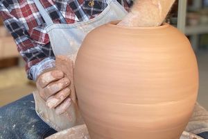 David Collins working on a large ceramic vase