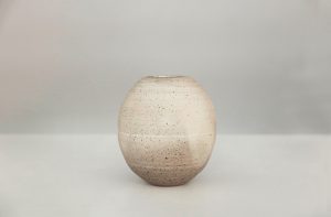 A small white vase made by David Collins