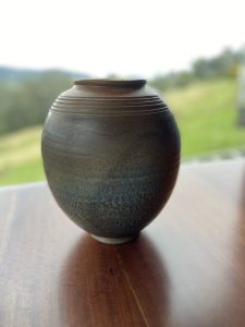 A blue vase with carvings made by David Collins