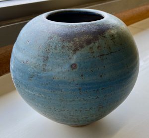 A blue round vase made by David Collins