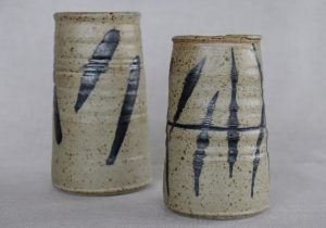 Small white and black vases made by David Collins