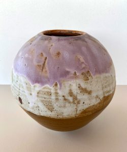 A purple, white and brown vase made by David Collins