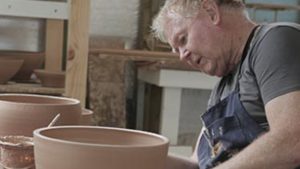 David Collins using a pottery wheel