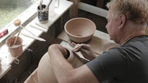 David Collins using a pottery wheel
