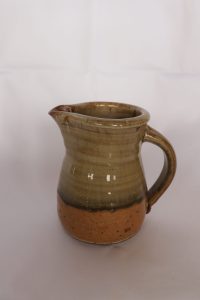A small Jug with a Brown Shiny Green Glaze created by David Collins