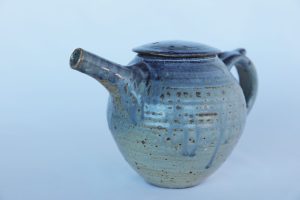 A Pottery Teapot with a blue ash glaze created by David Collins