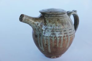 A Pottery Teapot with a brown ash glaze created by David Collins