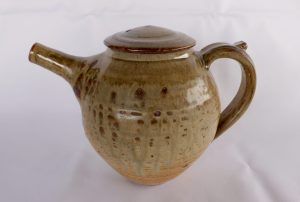 A Pottery Teapot with a brown ash glaze created by David Collins