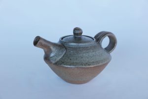 A small Pottery Teapot with a Blue glaze created by David Collins