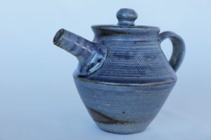 A small Pottery Teapot with a blue glaze created by David Collins