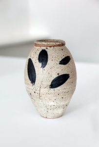 A Medium white Glazed Vase with blue leaves created By David Collins